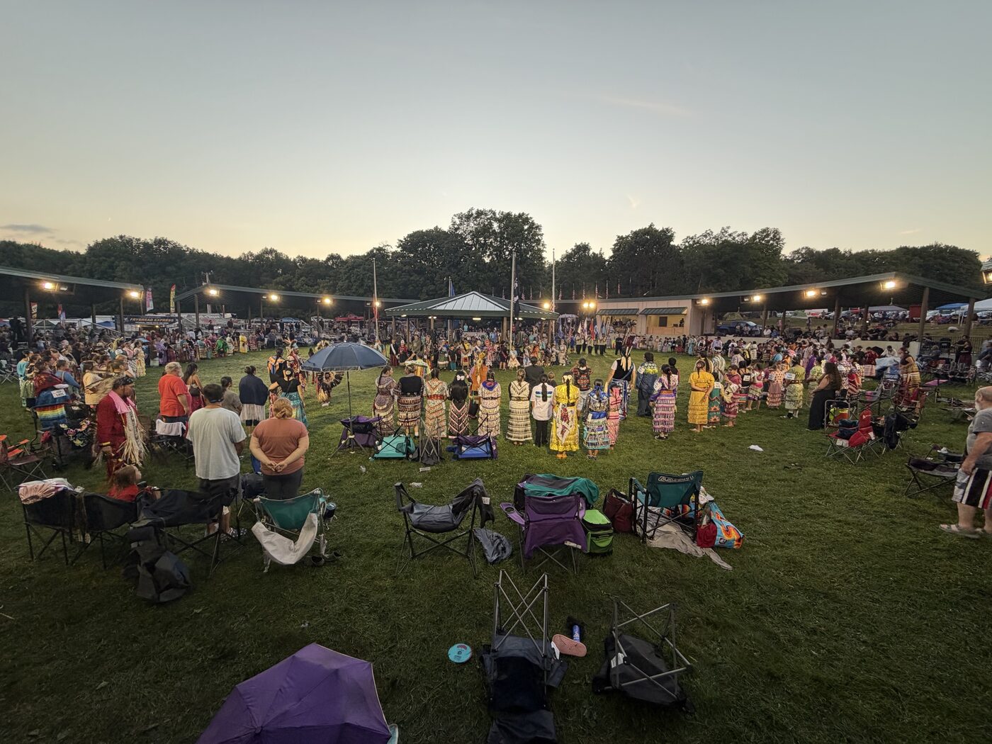 Dancers circling the arbor at dusk
